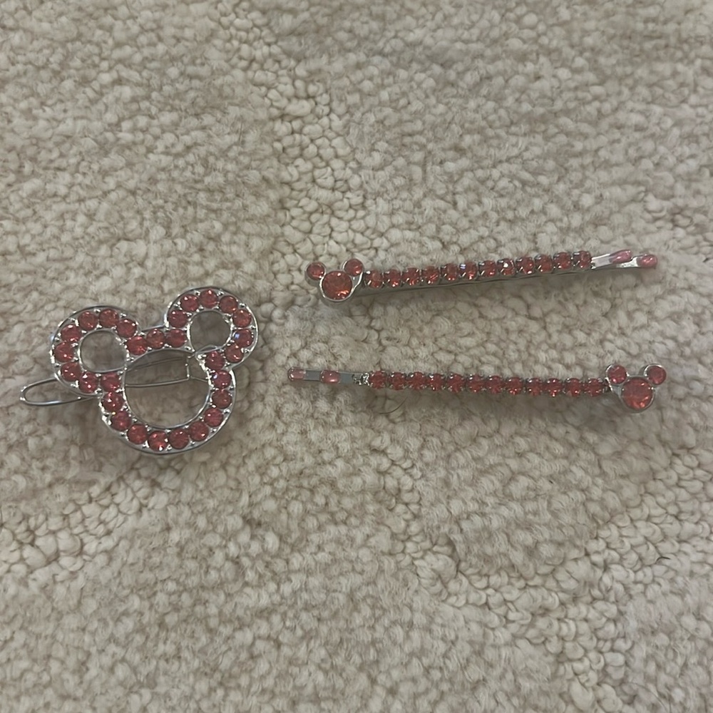 Pink Disney hair Bobby pins and a clip for a bun.